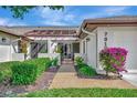 Front entry with walkway and nicely landscaped garden at 7317 Ballantrae Pl # 27B, Sarasota, FL 34238