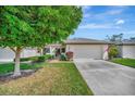 Exterior view showing a house with a large tree in front at 7317 Ballantrae Pl # 27B, Sarasota, FL 34238
