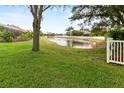 Backyard with pond view and lush landscaping at 1269 Western Pine Cir, Sarasota, FL 34240