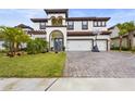 Two-story house with tile roof, three-car garage, and landscaped yard at 13891 Heartwood Way, Parrish, FL 34219