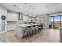 Spacious kitchen with white cabinets, large island, and modern appliances at 13891 Heartwood Way, Parrish, FL 34219