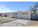 Tan house with a spacious front yard and driveway at 1518 Ewing Ave, Clearwater, FL 33756