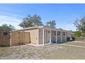 Tan house with a wooden fence and a grassy yard at 1518 Ewing Ave, Clearwater, FL 33756