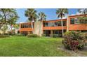 Condo building with grassy backyard and tropical plants at 153 Wild Palm Dr # 153, Bradenton, FL 34210