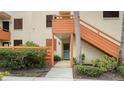 Orange stairs leading to condo entrance with landscaping at 153 Wild Palm Dr # 153, Bradenton, FL 34210