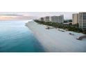 Aerial view of beachfront property with condos and beach access at 240 Sands Point Rd # 4201, Longboat Key, FL 34228
