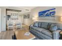 Living room with sofa and coffee table, open to kitchen area at 240 Sands Point Rd # 4201, Longboat Key, FL 34228