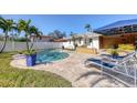 Inviting pool area with patio furniture and a pergola at 2425 Riverview Blvd, Bradenton, FL 34205