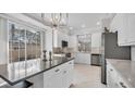 Modern kitchen with white cabinets, stainless steel appliances, and an island at 3484 Hadfield Greene # 22, Sarasota, FL 34235