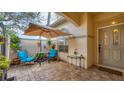 Cozy patio with a table, chairs, and umbrella, perfect for relaxing at 3484 Hadfield Greene # 22, Sarasota, FL 34235