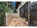 Private condo patio with flagstone flooring and a small table at 3500 El Conquistador Pkwy # 111, Bradenton, FL 34210