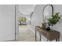 Entryway with console table, mirror, and view of living room at 3543 Woodmont Dr, Parrish, FL 34219