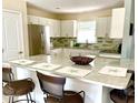 Kitchen island with seating for three at 3907 10Th Avenue W Dr, Bradenton, FL 34205