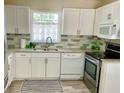 Well-equipped kitchen with white cabinets and new appliances at 3907 10Th Avenue W Dr, Bradenton, FL 34205