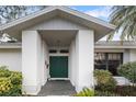 Covered entryway with a green door and decorative tile flooring at 4884 Huntleigh Dr, Sarasota, FL 34233