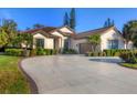 Elegant single-story home boasting a large driveway, tile roof and professionally landscaped yard at 5245 88Th E St, Bradenton, FL 34211