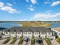 Aerial showcasing a row of townhouses near a lake at 6404 Silverstar Dr, Sarasota, FL 34240