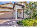 Front entry with stone accents and a two-car garage at 7014 Whittlebury Trl, Lakewood Ranch, FL 34202
