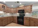 Spacious kitchen with light wood cabinets and black appliances at 8006 Oak Dr, Palmetto, FL 34221
