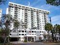 Modern condo building exterior with parking and American flag at 101 S Gulfstream Ave # 10E, Sarasota, FL 34236