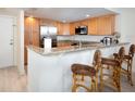 Modern kitchen with light wood cabinets, granite counters, and stainless steel appliances at 101 S Gulfstream Ave # 10E, Sarasota, FL 34236