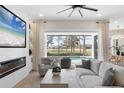 Living room features a fireplace and sliding doors opening to a pool and golf course view at 10114 Glenmore Ave, Bradenton, FL 34202