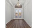 Bright and spacious entryway with double doors and elegant chandelier at 11323 Rivers Bluff Cir, Lakewood Ranch, FL 34202