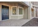 Close-up of a townhome entrance featuring a black door and a bay window at 12410 Osorio Ct # 101, Sarasota, FL 34238