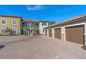 Townhome garages with a paved parking area, showcasing well-maintained exteriors at 12410 Osorio Ct # 101, Sarasota, FL 34238