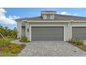 House exterior with gray garage door and walkway at 12681 Palatka Dr, Venice, FL 34293