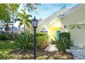 Front entrance with landscape and a black lamp post at 12732 Rockrose Gln, Lakewood Ranch, FL 34202