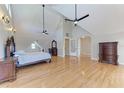 Spacious main bedroom with vaulted ceilings, dual ceiling fans, and hardwood floors at 1825 Bayshore Dr, Terra Ceia, FL 34250