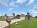 One-story home with a brick driveway and mailbox at 25067 Palisade Rd, Punta Gorda, FL 33983