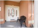 Ornate front door with sidelights and a decorative bench at 2720 S Biscayne Dr, North Port, FL 34287