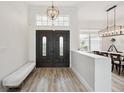 Bright and airy entryway with double doors and a modern bench at 2797 Harvest Dr, Sarasota, FL 34240