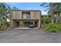 Exterior view of a two-story condo with carport and landscaping at 304 Pine Run Dr, Osprey, FL 34229