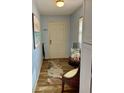 Bright entryway with tiled floor and wicker chair at 305 47Th Avenue W Dr # 143, Bradenton, FL 34207