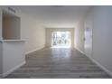 Bright living room with light gray vinyl flooring and sliding glass doors at 3259 Beneva Rd # 102, Sarasota, FL 34232