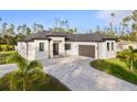 Modern single-story home with gray paver driveway and landscaping at 3782 Horace Ave, North Port, FL 34286