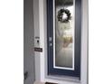Modern front door with decorative glass and a festive wreath at 4326 Silo Port Ct, Lakewood Ranch, FL 34211
