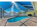 Relaxing kidney-shaped pool with covered patio at 4581 E Dover Street Cir, Bradenton, FL 34203