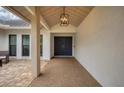 Covered entryway with a dark blue double door and a light-colored floor at 5179 Flicker Field Cir, Sarasota, FL 34231
