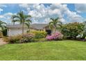 Single story home with a two car garage and manicured landscaping at 5179 Flicker Field Cir, Sarasota, FL 34231