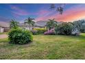 Single story home with landscaped yard, at sunset at 5179 Flicker Field Cir, Sarasota, FL 34231
