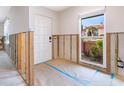 Renovation in progress, showing entryway with new door and exposed framing at 548 Ketch Ln, Longboat Key, FL 34228