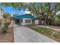 Cute teal home with a spacious yard and mature tree at 554 Canal Rd, Sarasota, FL 34242