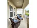 Relaxing front porch with wicker furniture at 5718 Westhaven Cv, Bradenton, FL 34203