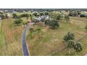 Aerial view of a farmhouse with a large yard and long driveway at 639 Oakford Rd, Sarasota, FL 34240