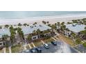 Aerial view of beachfront condo community with parking and ocean access at 6701 Gulf Of Mexico Dr # 317, Longboat Key, FL 34228