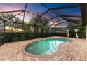 Relaxing kidney-shaped pool with covered patio at 6933 Quiet Creek Dr, Bradenton, FL 34212
